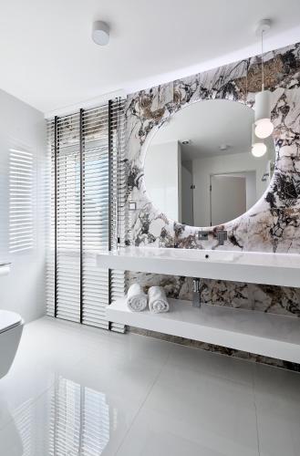 a bathroom with a mirror and a sink at Hotel Maria in Dębno Polskie