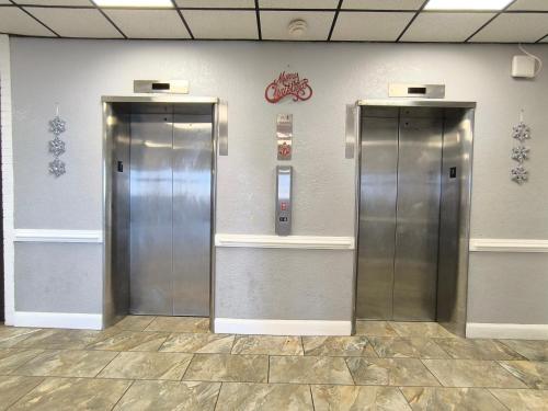 two metal elevators in a room with a wall at Ocean Resort in Virginia Beach