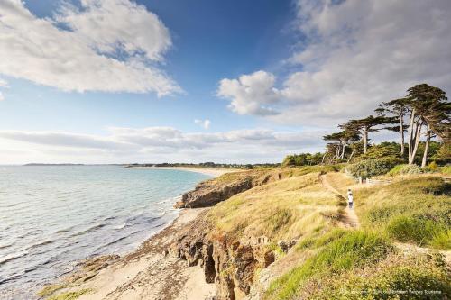 a person walking along a beach near the water at Maison médiévale de charme à Baden in Baden