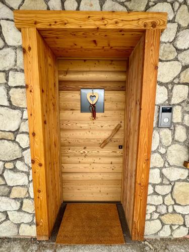 a wooden door in a stone wall at La Fenestra Cadore - Dolomiti in Pieve di Cadore