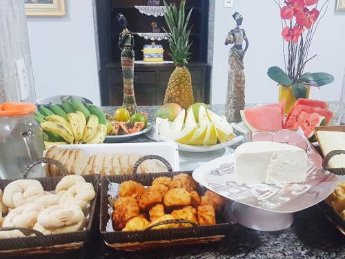 a table with many different types of food on it at Cerrado Gran Hotel in Rio Verde