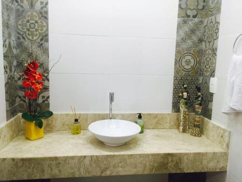 a bathroom with a white bowl sink on a counter at Cerrado Gran Hotel in Rio Verde