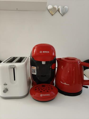 Un grille-pain rouge, un grille-pain et une cafetière sont fournis. dans l'établissement centre villeOpéra,Gare st Lazare , cozy studio, à Paris