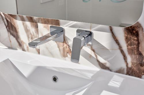 a bathroom sink with a chrome faucet at Hotel Maria in Dębno Polskie