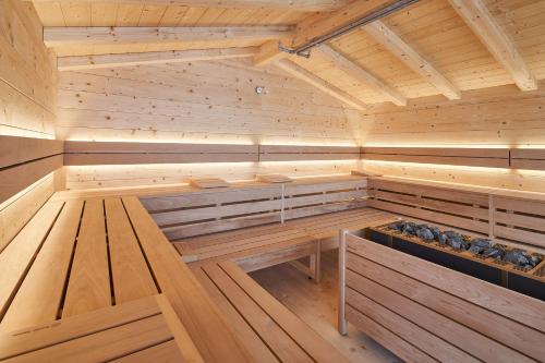 a wooden sauna with a bench in the middle at Riessersee Hotel in Garmisch-Partenkirchen