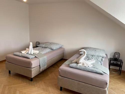 a room with two beds with white swans on them at Cozy Private Rooms in Wesseling in Wesseling