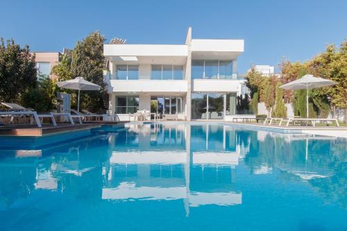a swimming pool in front of a building at Vivo Mare Beachfront Villas - Emerald in Ayia Napa