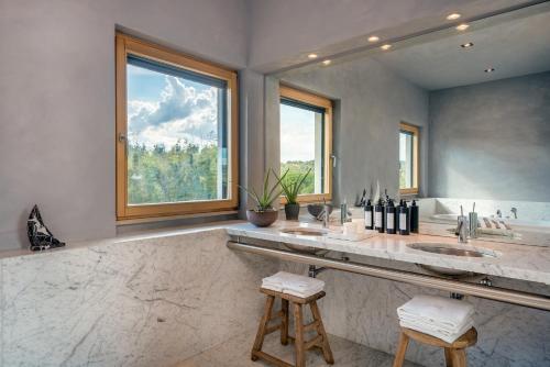a bathroom with a sink and a large window at O:live Villa Firenze in Lastra a Signa