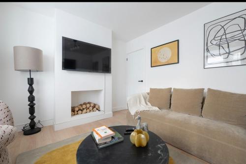a living room with a couch and a table at Cosy 4 bed with free parking, Chatham Town Centre in Chatham