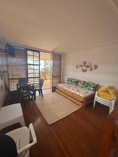 a living room with a bed and a table at Cabaña frente al mar de San Antero in San Antero