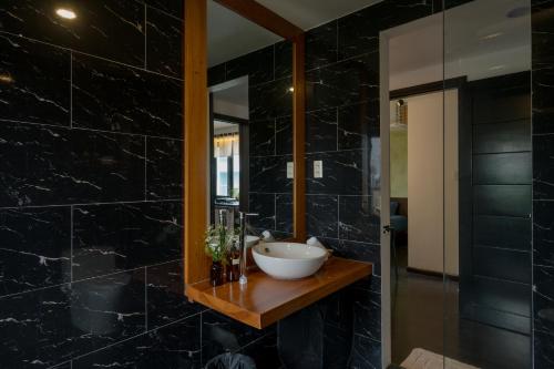 a bathroom with a sink and a mirror at Du De Homestay in Hoi An