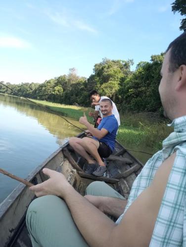 a group of people sitting in a boat on a river at Hotel Yurupary AMAZONAS in Leticia