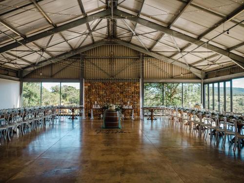 a large room with chairs and tables and windows at Zoetvlei Dairy House in Paterson