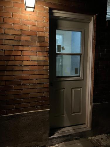 a door in a brick wall with a window at Stylish City Escape in Toronto