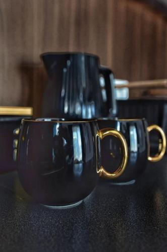two black coffee cups sitting on top of a table at Villa Corleone in Kąty Wrocławskie