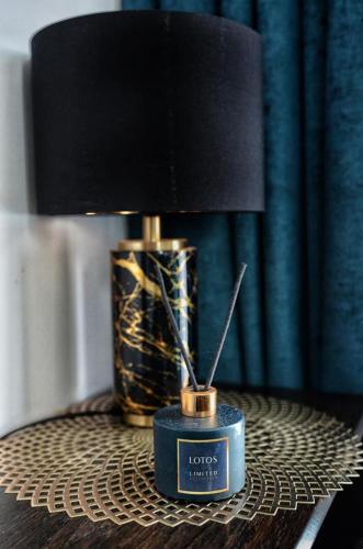 a table with a lamp on top of a table at Villa Corleone in Kąty Wrocławskie