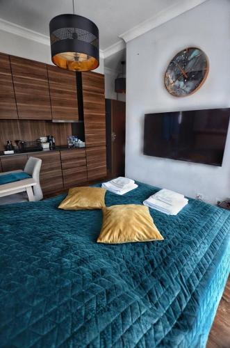 a bedroom with a large bed with two pillows on it at Villa Corleone in Kąty Wrocławskie