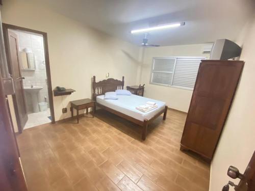 a bedroom with a bed and a sink in a room at Abaeté Palace Hotel in Abaeté