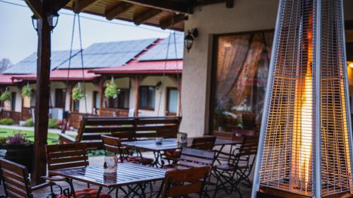 a patio with tables and chairs on a building at Németh Resort in Sovata