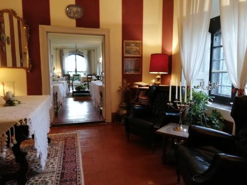 a dining room with a table and chairs and a room with at Il Giardino e la Dimora in Bomarzo