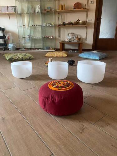 a room with three white chairs and a red rug on the floor at Wellness in Malpensa in Samarate