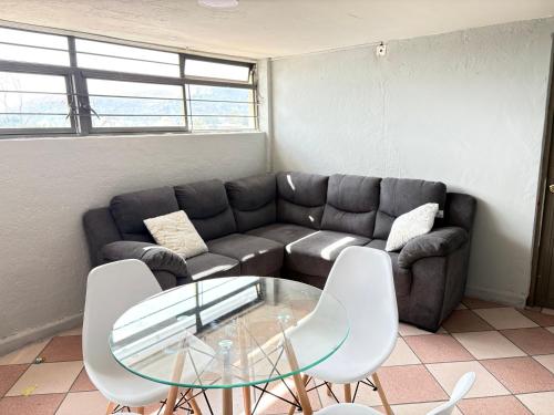 a living room with a couch and a glass table at Casa Luna in Oaxaca City