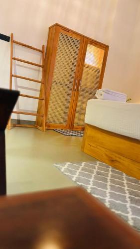 a room with a bed and a door and a ladder at Mount Side Hiriketiya in Hiriketiya