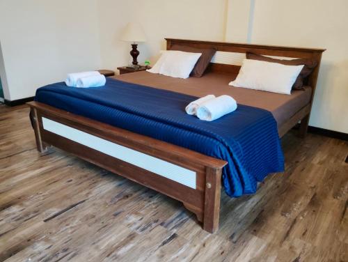 a bedroom with a bed with two towels on it at The Quale Villa in Galle