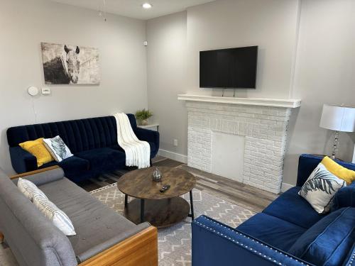 a living room with blue couches and a fireplace at Lovely 2BR Near Downtown Area in Columbus