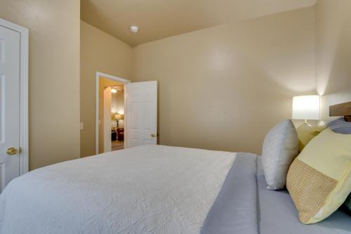 a bedroom with a large white bed with a lamp at Historic Home Half-Mile to Downtown Guthrie! in Guthrie