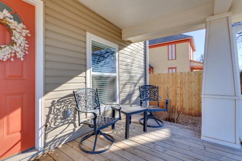 two chairs and a table on the front porch of a house at Historic Home Half-Mile to Downtown Guthrie! in Guthrie