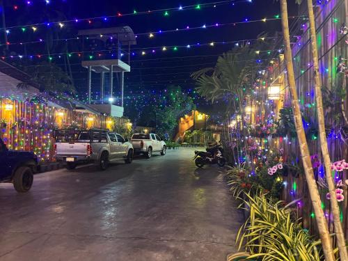 a parking lot with christmas lights in a building at U OLIVE Hotel in Ban Nua