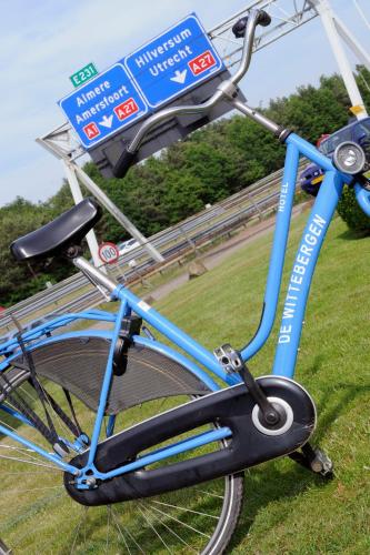 a blue bike parked next to a road sign at Van der Valk Hotel Hilversum/ De Witte Bergen in Hilversum
