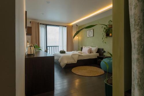 a hotel room with a bed and a window at Du De Homestay in Hoi An