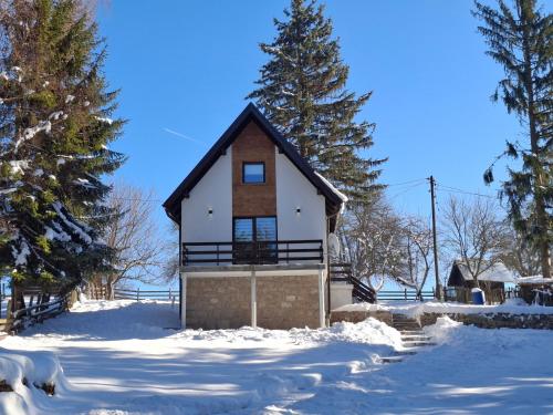 a small house in the snow with trees at Vikendica Sedam Patuljaka in Pale