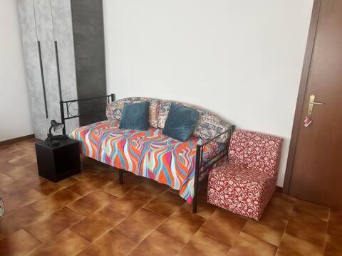 a couch and a chair in a room at Wellness in Malpensa in Samarate