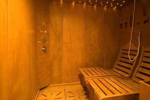 a wooden room with a bench and a wall with lights at Hotel Villa Ricci & Benessere in Chianciano Terme