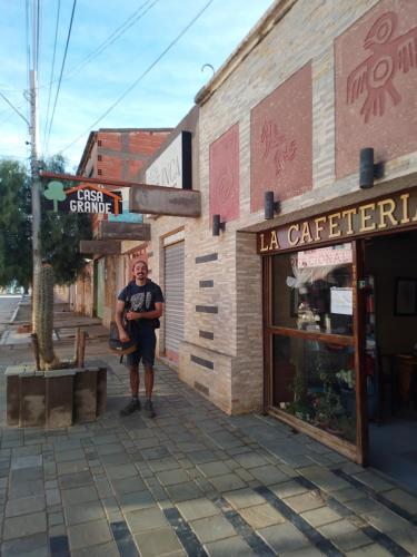 a man standing in front of a building at Hostal Casa Grande in Villazón