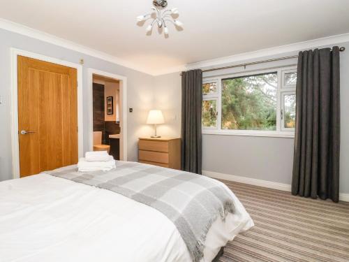 a bedroom with a bed and a window at The Pines in Skipton