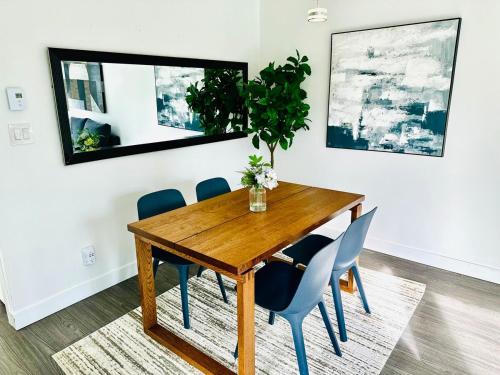a dining room with a wooden table and blue chairs at Luxury condo beach side Yaletown in Vancouver