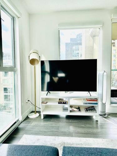 a living room with a large flat screen tv at Beautiful condo beach side Yaletown in Vancouver