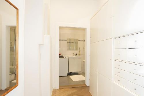 a white bathroom with a sink and a mirror at Fewo Romeo und Julia in Bamberg
