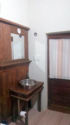 a bathroom with a wooden sink and a mirror at Hostal Casa Grande in Villazón