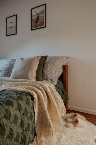 a bedroom with a bed with a blanket on it at Łąckie Zacisze in Łącko
