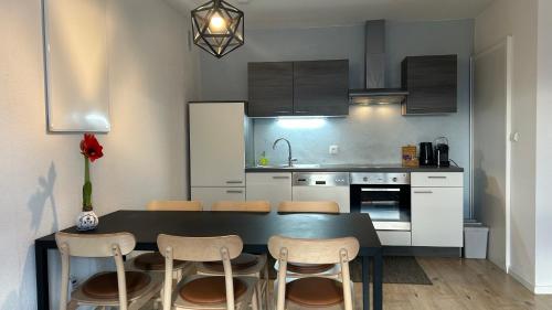 a kitchen with a black table and chairs in a room at Feriendomizil Suldis in Batschuns