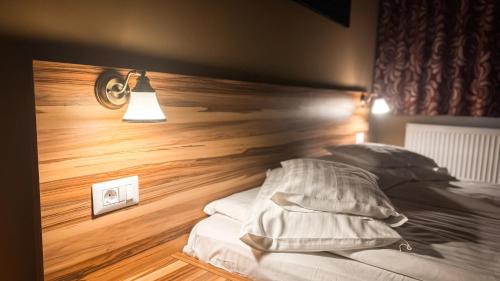 a bedroom with a bed with a wooden floor at Németh Resort in Sovata