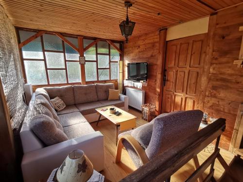 a living room with a couch and a table at Vikendica Jagodica in Ivanjica