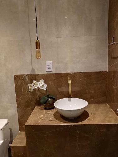 a bathroom with a bowl sink on a counter at Casa Portal do Sol JP in João Pessoa