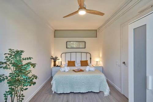 a bedroom with a bed and a ceiling fan at BBarcelona Gracia Apartment in Barcelona