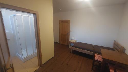 a room with a bench and a table and a door at Penzion Staré Sedlo in Bor